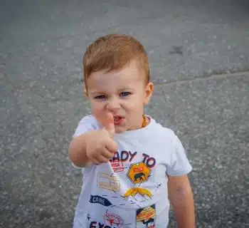 a baby with his finger in his mouth