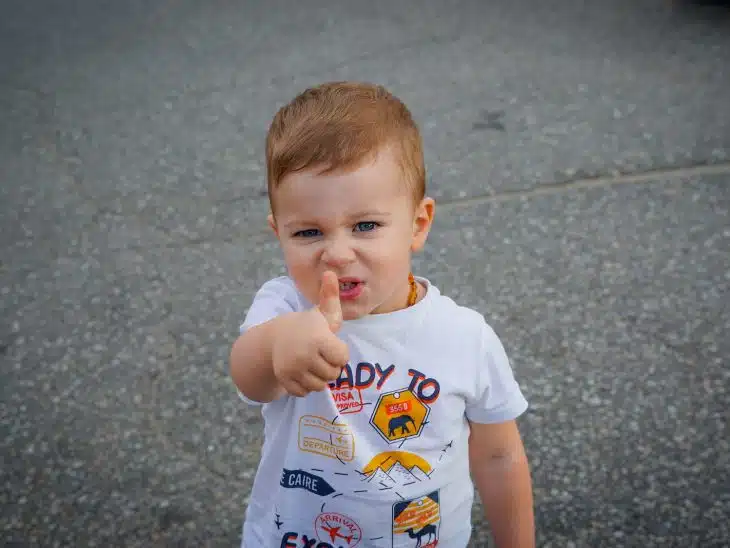 a baby with his finger in his mouth