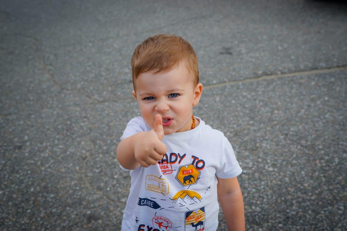 a baby with his finger in his mouth